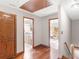 Hallway with hardwood flooring leading to a bathroom and bedroom, with neutral-colored walls at 35 Tracechain, Stockbridge, GA 30281