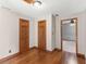 Hallway features hardwood floors, neutral walls, and wood trim around doors and baseboards at 35 Tracechain, Stockbridge, GA 30281