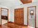 Hallway with hardwood floors featuring access to main bedroom, closet, and another room at 35 Tracechain, Stockbridge, GA 30281