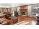 Open living room flows into the kitchen, featuring a brick fireplace and leather furniture at 35 Tracechain, Stockbridge, GA 30281