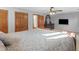Main bedroom features a ceiling fan, TV, hardwood trim, and neutral-colored walls at 35 Tracechain, Stockbridge, GA 30281