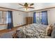 Comfortable main bedroom featuring a large bed, windows with natural light, and a ceiling fan at 35 Tracechain, Stockbridge, GA 30281
