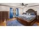 Spacious main bedroom featuring a large bed, wood floors, and a window with blue curtains at 35 Tracechain, Stockbridge, GA 30281