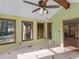 Well-lit sun room with tiled floors, ceiling fan, and many windows overlooking trees at 35 Tracechain, Stockbridge, GA 30281
