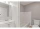 Bright bathroom with a white vanity, a mirror, and a tiled bath and shower at 5074 Park Ave, Forest Park, GA 30297