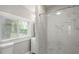 Modern bathroom featuring marble-like tiling in the shower, a window, and a new vanity at 5074 Park Ave, Forest Park, GA 30297