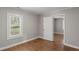 Bedroom with hardwood floors, window, and neutral paint throughout at 5074 Park Ave, Forest Park, GA 30297