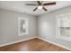 Bedroom with hardwood floors, ceiling fan, and natural light from two windows at 5074 Park Ave, Forest Park, GA 30297