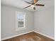 Bedroom featuring hardwood floors, a ceiling fan, and a window with natural light at 5074 Park Ave, Forest Park, GA 30297