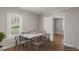 Staged dining room with a square table set for six, next to a window and doorway at 5074 Park Ave, Forest Park, GA 30297