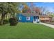 Charming blue home with a well-maintained front lawn and beautiful landscaping at 5074 Park Ave, Forest Park, GA 30297