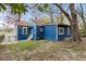 A blue cottage-style home with trees and gate in background at 5074 Park Ave, Forest Park, GA 30297