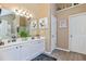 Bathroom with dual sinks, quartz countertops, and modern lighting at 7847 Wrotham Cir, Atlanta, GA 30349