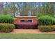 Community sign for Legacy at Palmetto Farms surrounded by manicured bushes and colorful flowers at 7847 Wrotham Cir, Atlanta, GA 30349