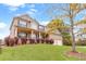 Beautiful two-story brick home with a well-maintained lawn and landscaping with a tree at 7847 Wrotham Cir, Atlanta, GA 30349