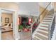 Inviting foyer with staircase leading to the upper level and view into living room at 7847 Wrotham Cir, Atlanta, GA 30349