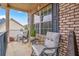 Front porch with two gray chairs, a small table and brick exterior at 7847 Wrotham Cir, Atlanta, GA 30349