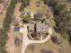 Aerial view of the home showcasing its beautifully landscaped yard and surrounding wooded acreage at 8906 E Carroll Rd, Winston, GA 30187