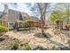 Expansive backyard with stone patio, mature trees, and garden, creating a private outdoor retreat at 8906 E Carroll Rd, Winston, GA 30187