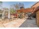 A stone patio, pergola, and meticulous landscaping creates a captivating backyard space for leisure and entertainment at 8906 E Carroll Rd, Winston, GA 30187