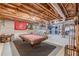 Spacious unfinished basement with exposed ceiling, concrete floor, and a game area centered on a pool table at 8906 E Carroll Rd, Winston, GA 30187