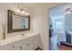 Bathroom with a large mirror, white marble countertops, and view to another room at 8906 E Carroll Rd, Winston, GA 30187