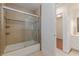 Bright bathroom featuring a tiled shower-tub, neutral tiling, and a sleek vanity with ample storage at 8906 E Carroll Rd, Winston, GA 30187