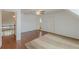 Bonus room featuring a large carpet, wooden floors, and view to other rooms at 8906 E Carroll Rd, Winston, GA 30187