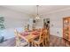 Traditional dining room with wooden floors, crown molding, and a stylish light fixture at 8906 E Carroll Rd, Winston, GA 30187