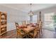 Formal dining room with a wood table, decorative light fixture, and wood flooring at 8906 E Carroll Rd, Winston, GA 30187