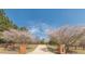 A charming tree-lined driveway with mature flowering trees provides an inviting approach to the home at 8906 E Carroll Rd, Winston, GA 30187