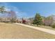 Charming home featuring a covered porch, a long driveway, mature trees, and lush green lawn at 8906 E Carroll Rd, Winston, GA 30187