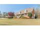 Attractive brick home boasting a manicured lawn, decorative shrubbery, and a side-entry three-car garage at 8906 E Carroll Rd, Winston, GA 30187