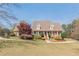 Charming brick home featuring mature landscaping, a covered porch, and a long, private driveway at 8906 E Carroll Rd, Winston, GA 30187
