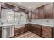 Elegant kitchen with a farmhouse sink, stainless steel appliances, and a window overlooking the yard at 8906 E Carroll Rd, Winston, GA 30187