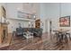 Bright living room showcasing a fireplace, high ceilings, and dark wood flooring at 8906 E Carroll Rd, Winston, GA 30187