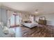 Spacious main bedroom featuring a decorative ceiling fan, french doors, and dark hardwood floors at 8906 E Carroll Rd, Winston, GA 30187