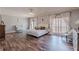 Bright main bedroom with dark hardwood floors, light gray walls, and ample natural light at 8906 E Carroll Rd, Winston, GA 30187