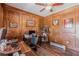 Inviting office with wood paneling, a ceiling fan, and built-in shelving at 8906 E Carroll Rd, Winston, GA 30187