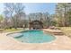 Inviting pool area featuring a sun-soaked patio and beautiful landscaping, perfect for enjoying sunny days at 8906 E Carroll Rd, Winston, GA 30187