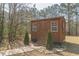 Well-maintained backyard shed with a charming entrance, offering additional storage at 8906 E Carroll Rd, Winston, GA 30187