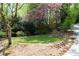 Private backyard with a stone bench sitting atop a circular lawn at 1209 The By Ne Way, Atlanta, GA 30306
