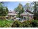 Lush backyard features mature trees, patio with outdoor seating, and manicured garden beds at 1209 The By Ne Way, Atlanta, GA 30306