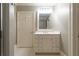 Bright bathroom features a white vanity with ample storage and a large mirror, perfect for everyday use at 1209 The By Ne Way, Atlanta, GA 30306