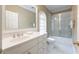 Bathroom featuring a white vanity with a large mirror and tiled shower-tub surround at 1209 The By Ne Way, Atlanta, GA 30306
