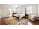 Light and airy bedroom featuring a four-poster bed, hardwood floors, plantation shutters, and neutral paint at 1209 The By Ne Way, Atlanta, GA 30306