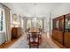Formal dining room with hardwood floors, a chandelier, large windows, and built-in cabinets at 1209 The By Ne Way, Atlanta, GA 30306