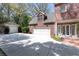 Spacious driveway leading to a two-car garage and separate single-car garage on a traditional brick home at 1209 The By Ne Way, Atlanta, GA 30306