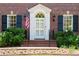 Close up view of the front door with white trim, sidelights, and a hanging American flag at 1209 The By Ne Way, Atlanta, GA 30306
