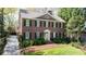 Beautiful two-story brick home with classic shutters, an arched doorway, and manicured landscaping at 1209 The By Ne Way, Atlanta, GA 30306